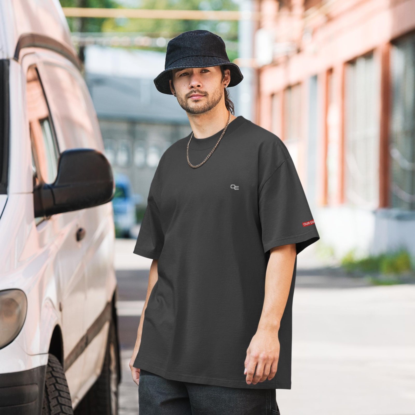 oversized-faded-t-shirt-faded-black-front-67ec06c83ba6e.jpg t-shirt by our era worn by a man wearing shades on a psychedelic skulls background